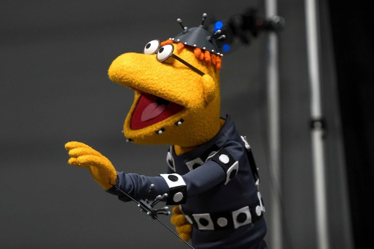 Scooter the Muppet wearing a black motion-capture suit
