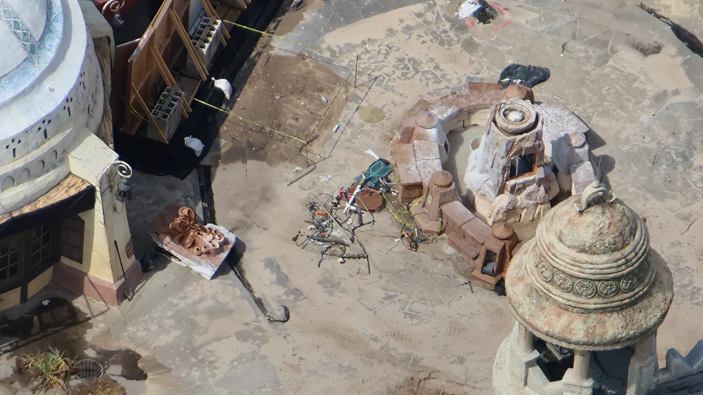 The Mystic Fountain's carved face removed and set on the ground during demolition
