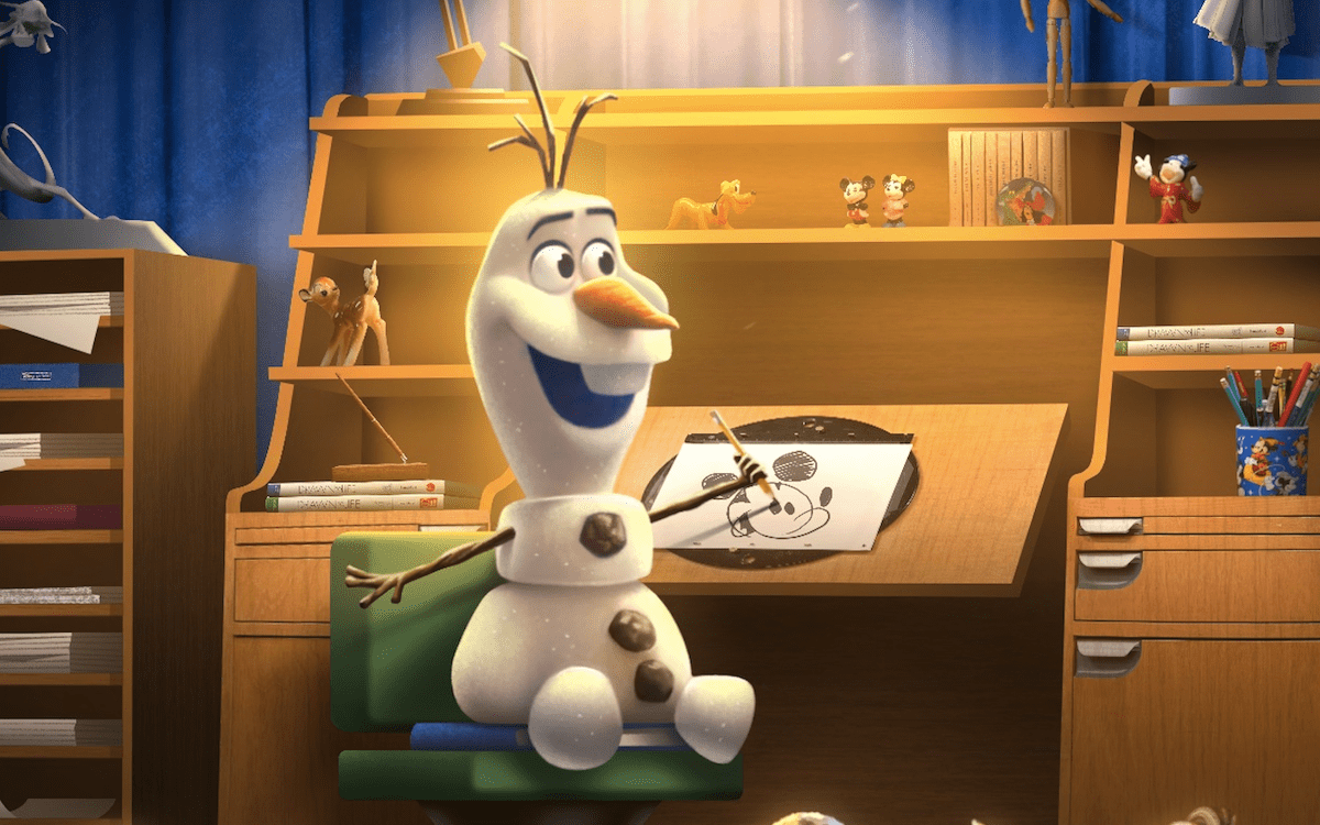 The new Olaf Audio-Animatronics figure seated at an animator's desk for Olaf Draws! at The Magic of Disney Animation