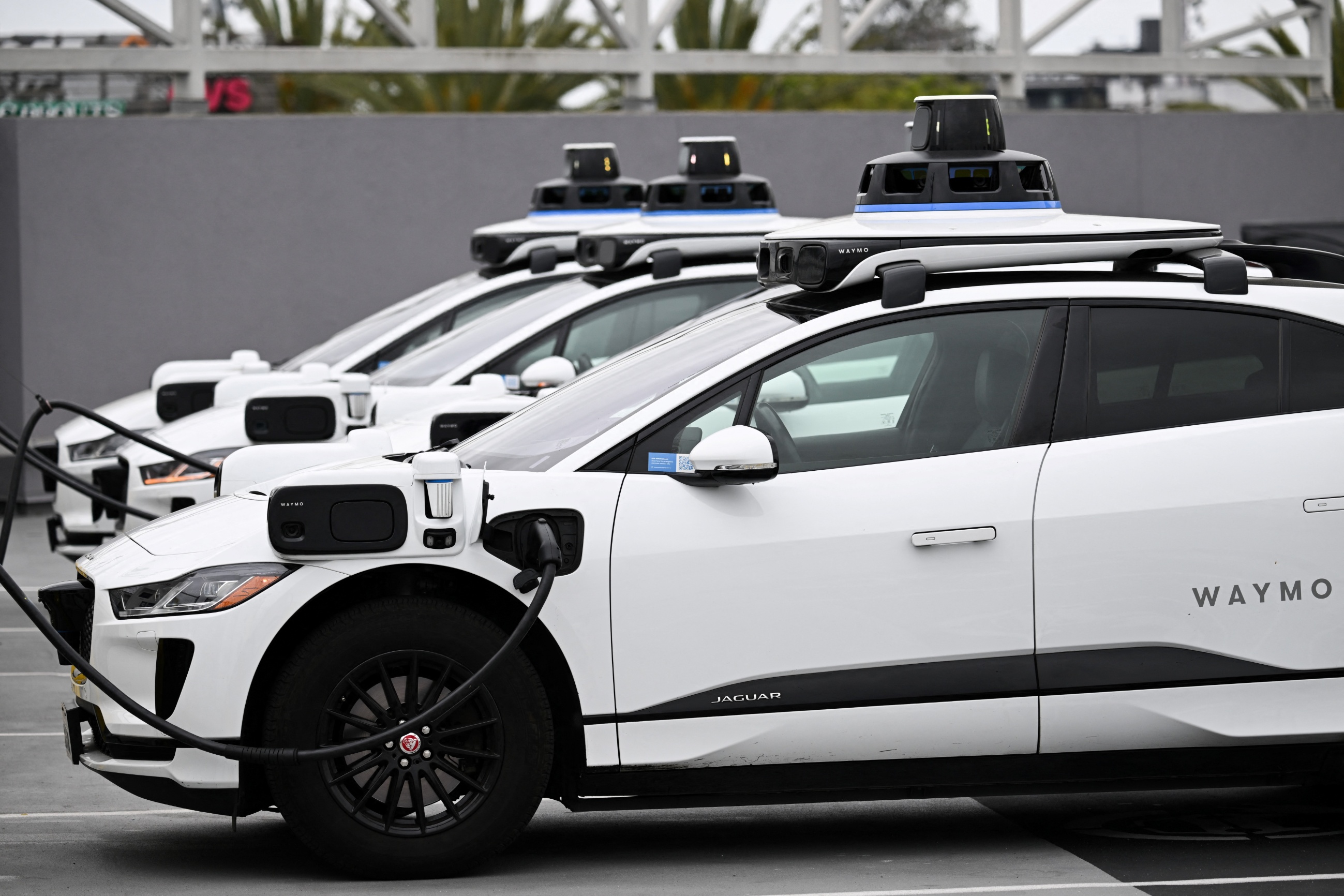 A Waymo autonomous Jaguar parked at an EVgo charging station in Los Angeles.