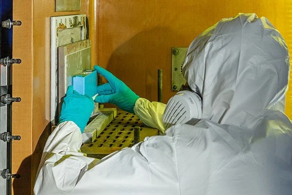 A prismatic battery cell being placed into the Fraunhofer EMI high-speed X-ray test chamber.