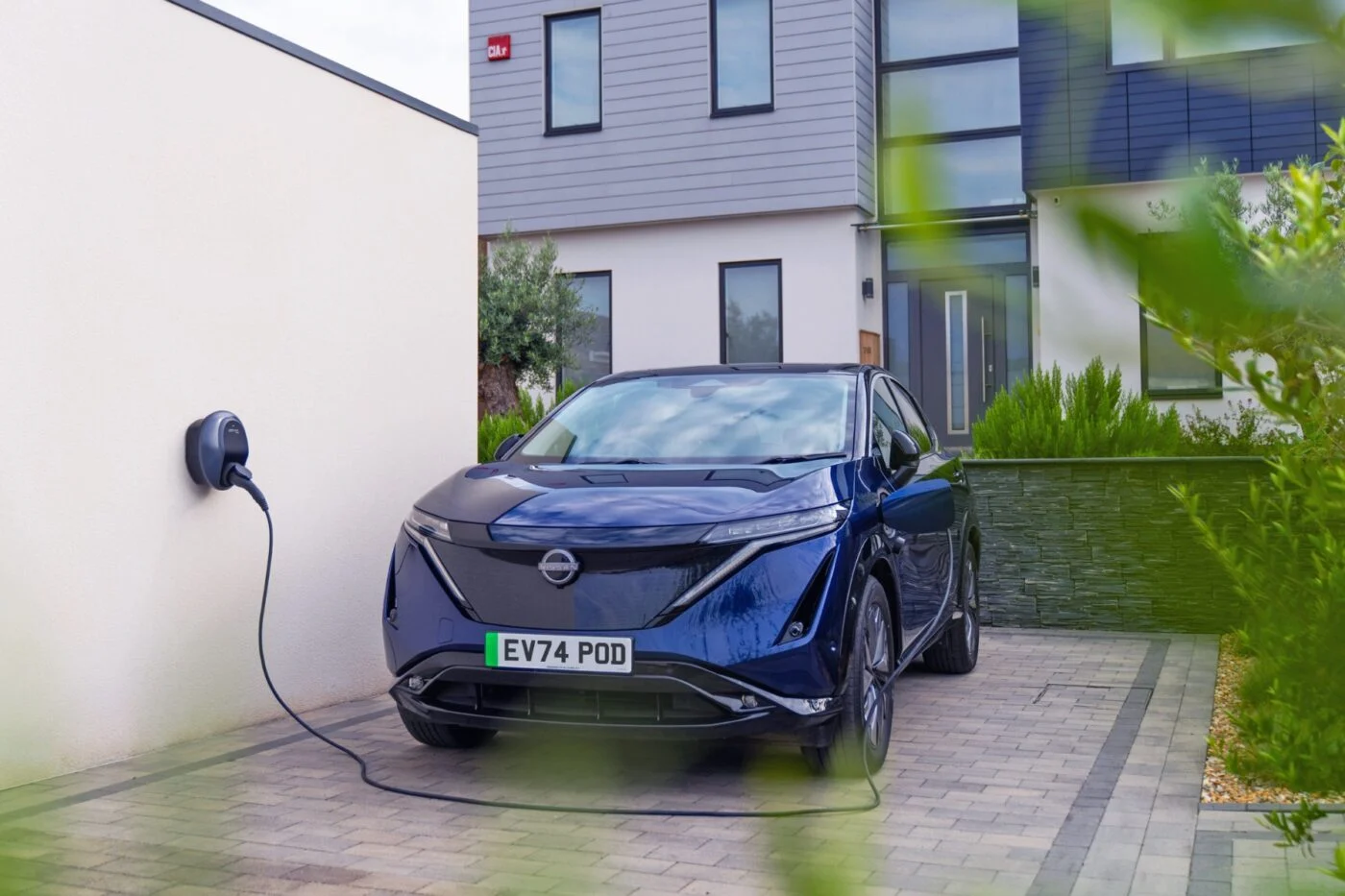 A Nissan EV charging at a UK wallbox.